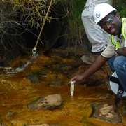 Alan Kumassah conducting water samples on a diversion at the Oak Hill mine in Rusk County, Texas